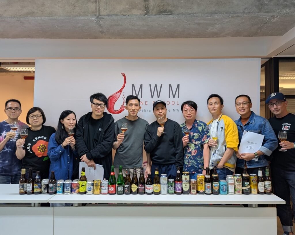 Professional beer tasting setup with Cicerone study materials and various beer styles in clean glassware. Kenneth Ho demonstrating professional beer service and glassware cleaning for the Cicerone Certified Beer Server preparation course.